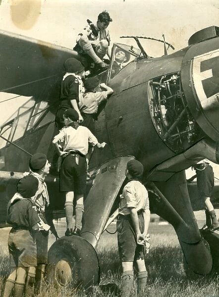 Air Scouts climbing on plane with Lord Olivier