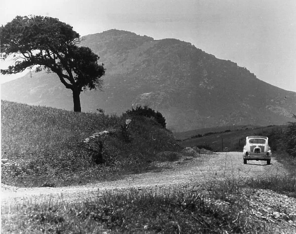 Car on a country road, Sardinia, Italy