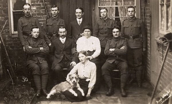 Group photo with soldiers and dog in yard