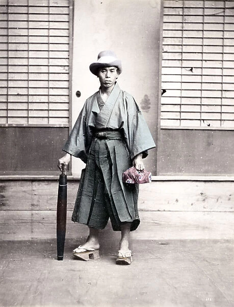 Japanese man in outdoor shoes and with umbrella, Japan