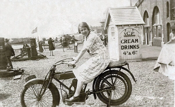Lady on vintage motorcycle at the seaside