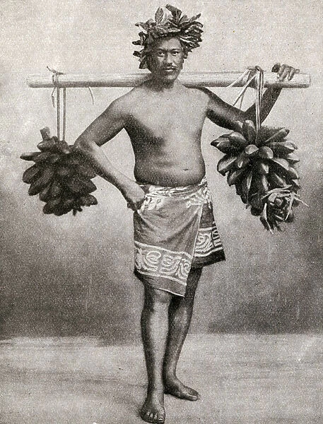 Man carrying fruit on a pole, Tahiti, French Polynesia