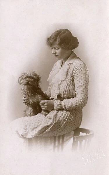 Studio portrait, woman with Yorkshire terrier