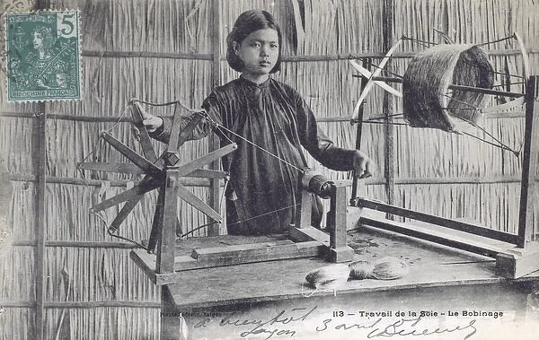 Vietnamese girl spinning silk by hand