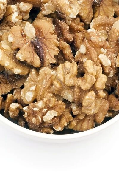 Walnuts ( Juglans regia. ) in a bowl. Walnuts are a goodsource of vitamin E