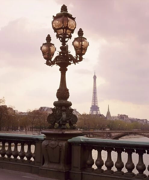 The Eiffel Tower seen from the Pont Alexandre III at dusk, Paris, France