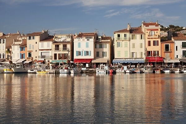 Fishing boats at the harbour, restaurants and street cafes on the promenade, Cassis