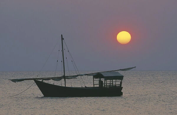 10095707. TANZANIA Lake Tanganyika Sunset with dhow at anchor