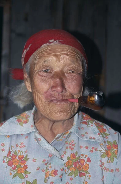 20056642. RUSSIA Lake Baikal Portrait of elderly Buryat woman smoking pipe