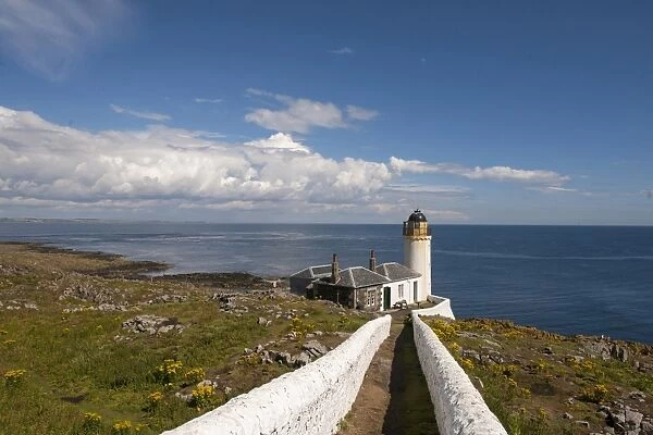 View of coastline and bird observatory housed in former lighthouse, Low Light, Isle of May, Firth of Forth, Scotland
