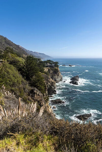 The rugged coastline of Big Sur with wisps of fog drifting into the hills