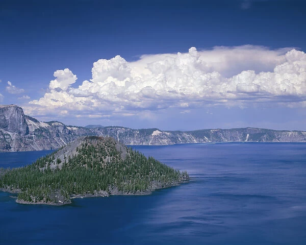 USA, Oregon. Crater Lake National Park, thunder clouds float over Wizard Island and Crater Lake