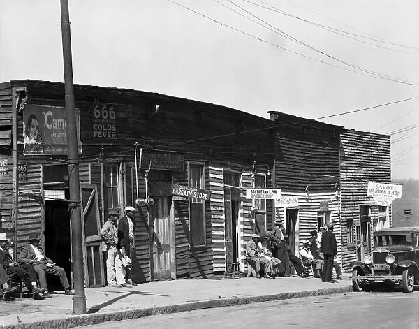 BARBERSHOPS, 1936. A row of African American barbershops in Vicksburg, Mississippi