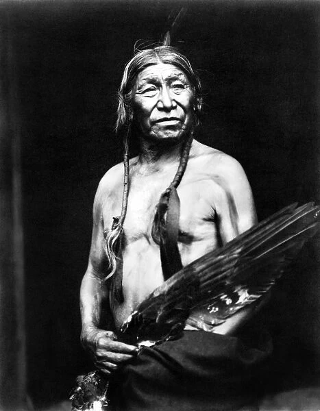 BOBTAILHORSE, c1913. Bobtailhorse, a Blackfoot Native American, photographed holding a large bird wing, c1913