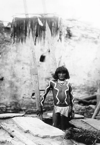 HOPI MAN, 1897. A Hopi man wearing a breechcloth and body paint, standing on a
