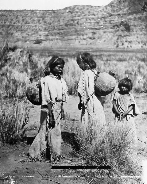 PAIUTE WATER CARRIERS. Two Paiute girls carrying water in jugs on the Kaibab Plateau