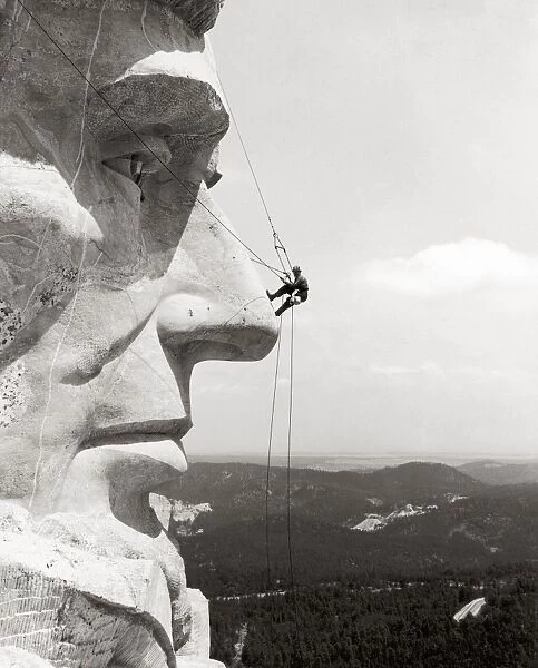 SCALING MOUNT RUSHMORE. Scaling the face of President Abraham Lincoln at the Mount Rushmore National Memorial in South Dakota, 1937