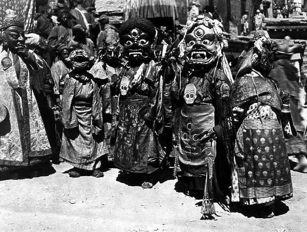 Tibetan monks wearing masks, each symbolizing a mental defilement. Film still, mid-20th century