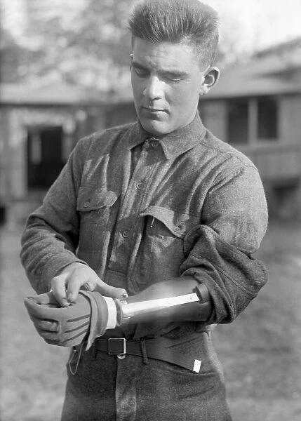 WWI: VETERAN, c1917. A veteran of World War I wearing a prosthetic arm, possibly