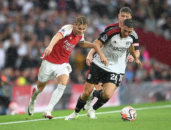Arsenal's Martin Odegaard Clashes with Fulham's Joao Palhinha in Premier League Showdown at Emirates Stadium (2023-24)