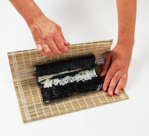 2 - Use the mat to help roll the nori round the rice