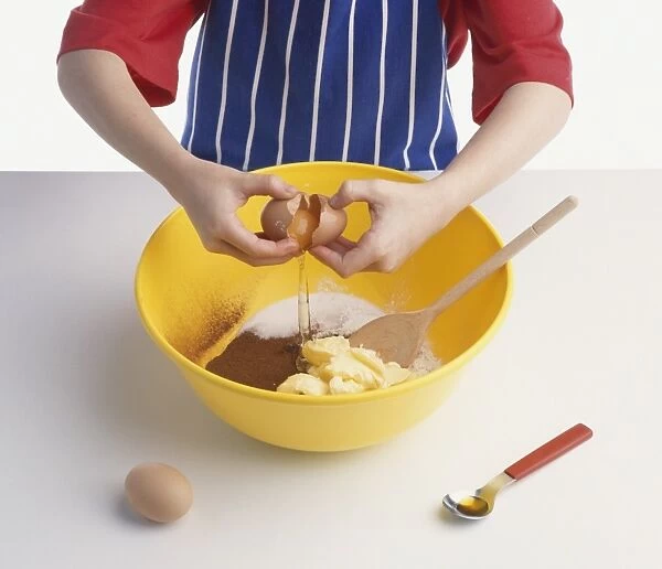 Adding ingredients for a chocolate sponge cake in a mixing bowl