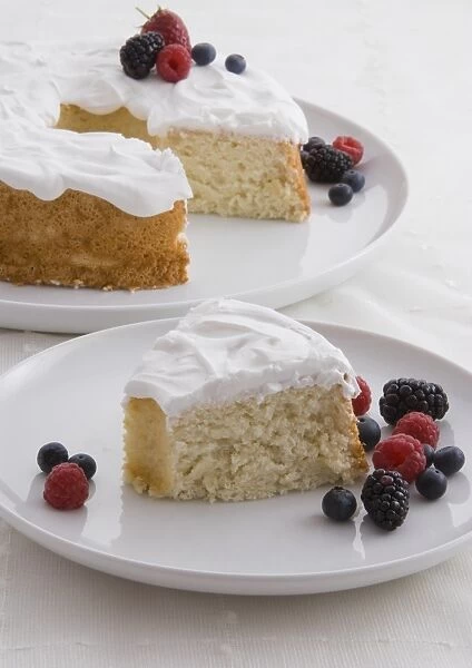 Angel Food Cake, cake with meringue topping, single slice served with fresh berries in the foreground, close-up
