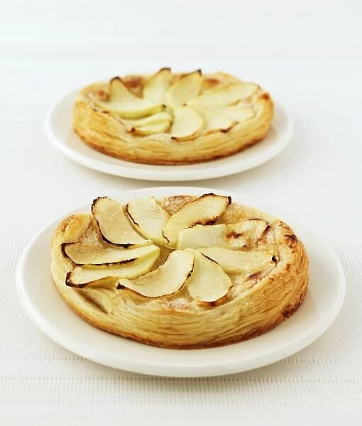 Apple and almond galettes served on white plates