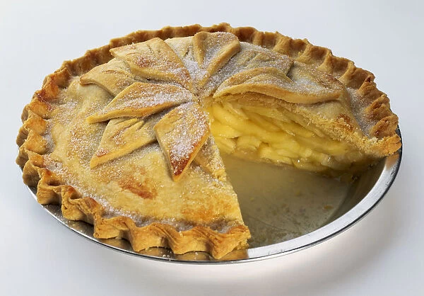 An apple pie with a section cut out of it, close-up