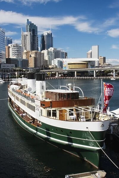 Australia, New South Wales, Sydney, National Maritime Museum in old fashioned ferry moored in Darling Harbour with skyscrapers in background