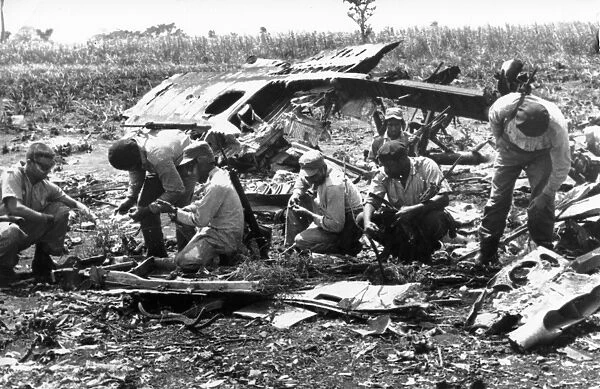 Bay of pigs, 1961, cuban militia examining the wreckage of plane shot down by artillery fire