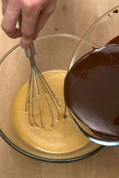 Beating in a chocolate mixture to a mixture of eggs, sugar and vanilla extract to make chocolate brownies