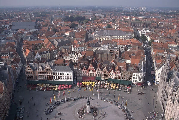Belgium, Bruges, view from the Belfort, of medieval houses and streets around a market square lined with cafes and restaurants