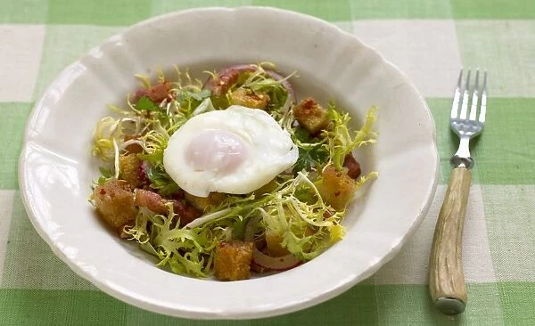 Bistro salad with frisee lettuce, poached egg, bacon lardons and croutons
