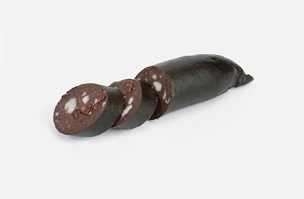 Black pudding with some slices cut away, close-up