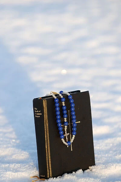 Book of common prayer and rosary on snow. Norway