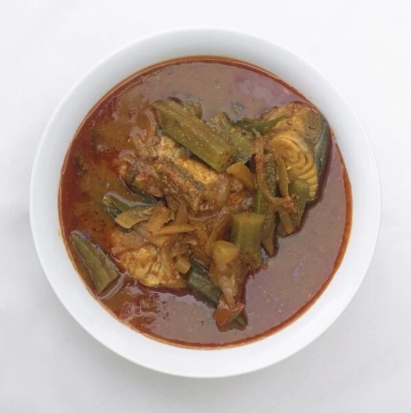 Bowl of Assam Pedas, a Malay dish of fish, brinjal and okra in tamarind-based sauce, view from above