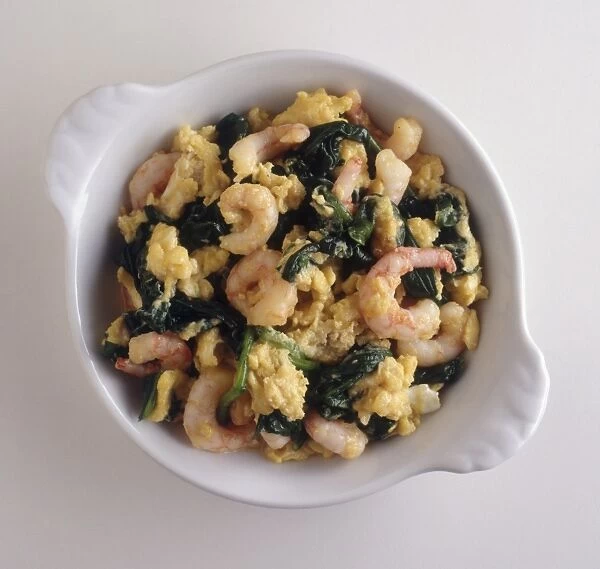 Bowl of Revuelto, containing scrambled eggs, spinach and prawns, a traditional dish from Northern Spain, view from above