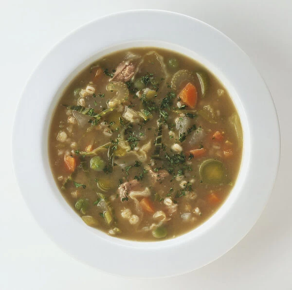 A bowl of Scotch Broth, containing pearl barley and vegetables, view from above