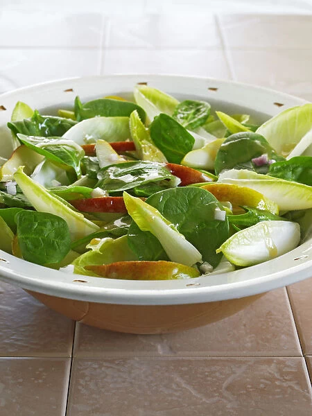 Bowl of spinach, pear and chicory salad, close-up