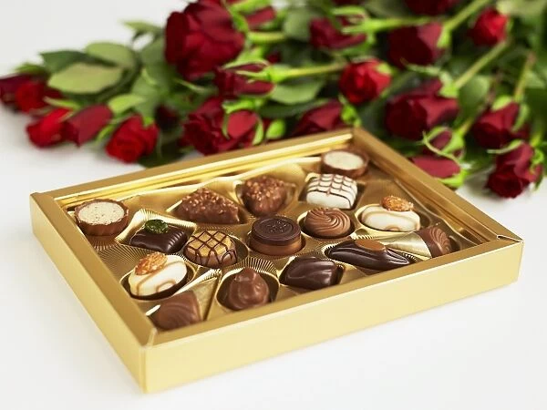 Box of chocolates and red roses, close-up