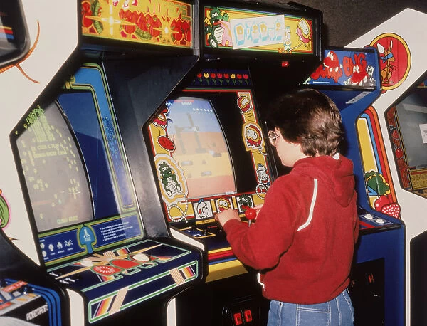 Boy playing video arcade games