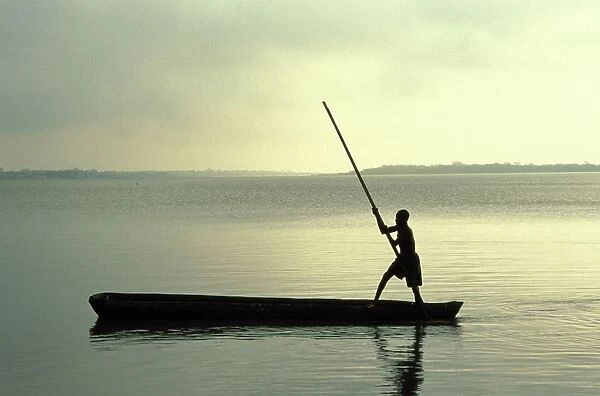 Boy rowing on Lake Togo, Aneho, Togo