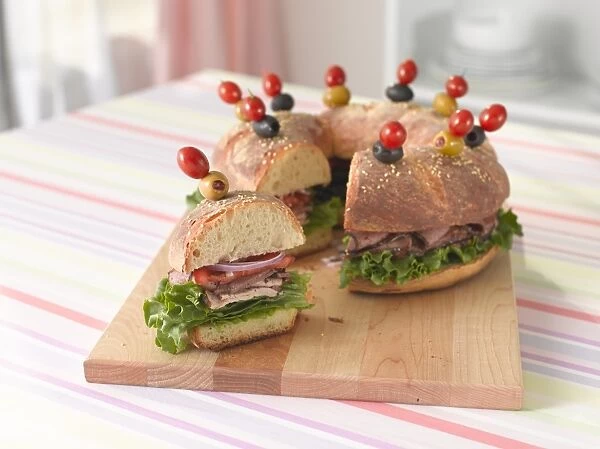 Bread ring stuffed with turkey, pastrami, tomatoes, onions and lettuce, and garnished with cherry tomatoes and olives