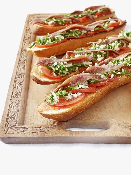 Bruschetta, bread topped with anchovies, tomato, spring onion
