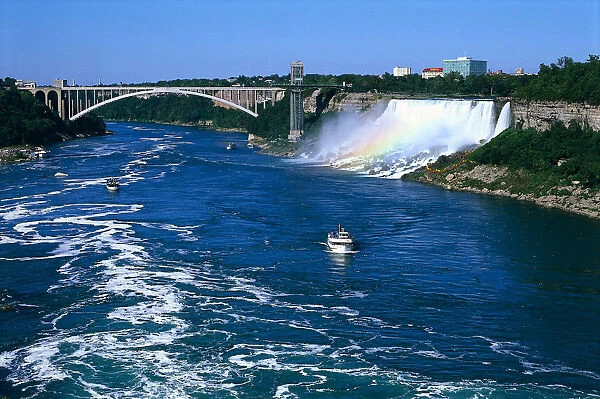 Canada, Ontario, rainbow over the Niagara Falls, with boats sailing down the Niagara river