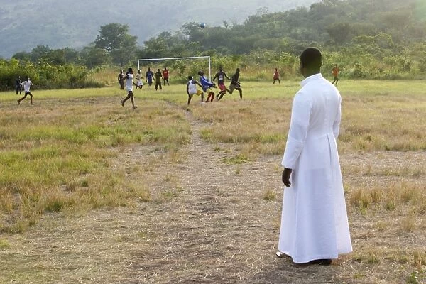 Catholic priest watching a soccer game