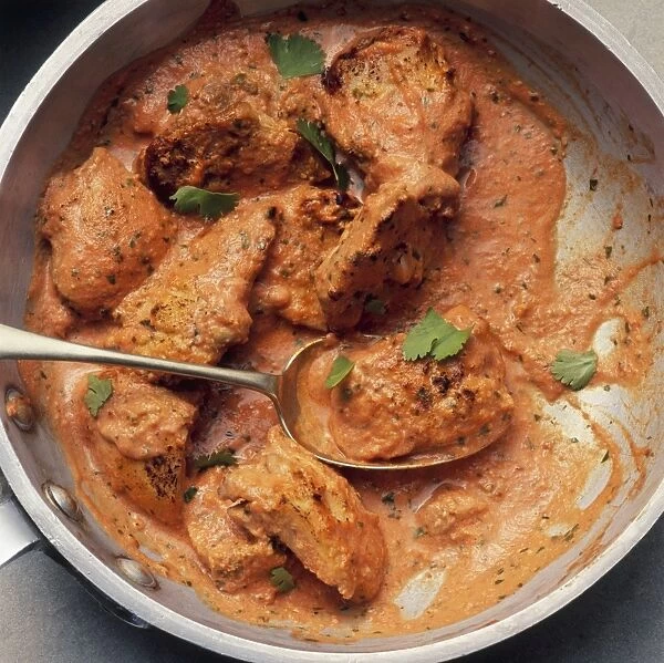 Chicken tikka masala in pan with spoon