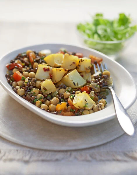 Chickpea, lentil and potato dish in bowl, close-up