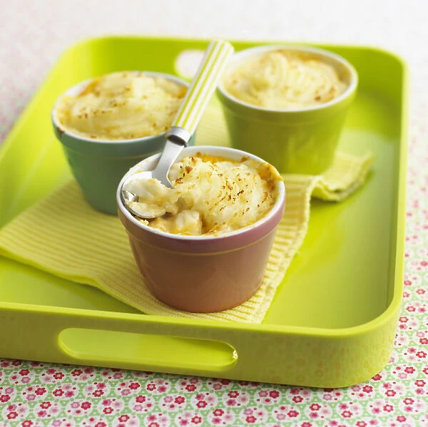 Childrens food of mini fish pies on tray with spoon and napkin